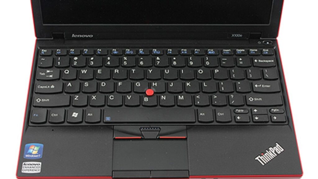 A Lenovo ThinkPad X100e laptop with a black keyboard and a red trackpoint.