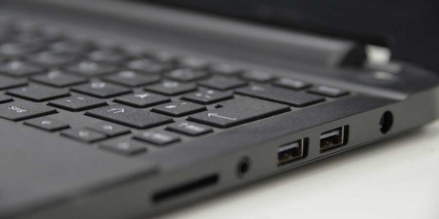 Close-up view of a laptop keyboard and its side ports like USB Ports and power jack